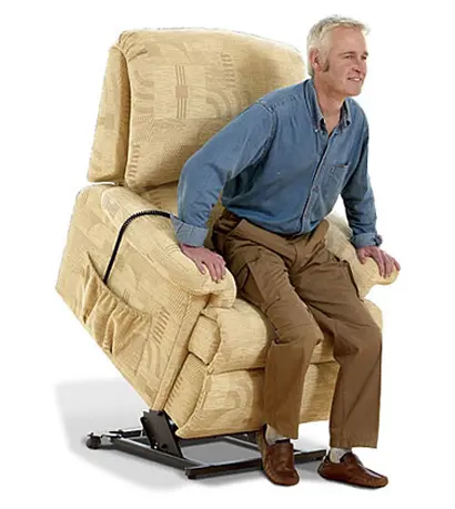 A man sitting on top of a beige recliner.
